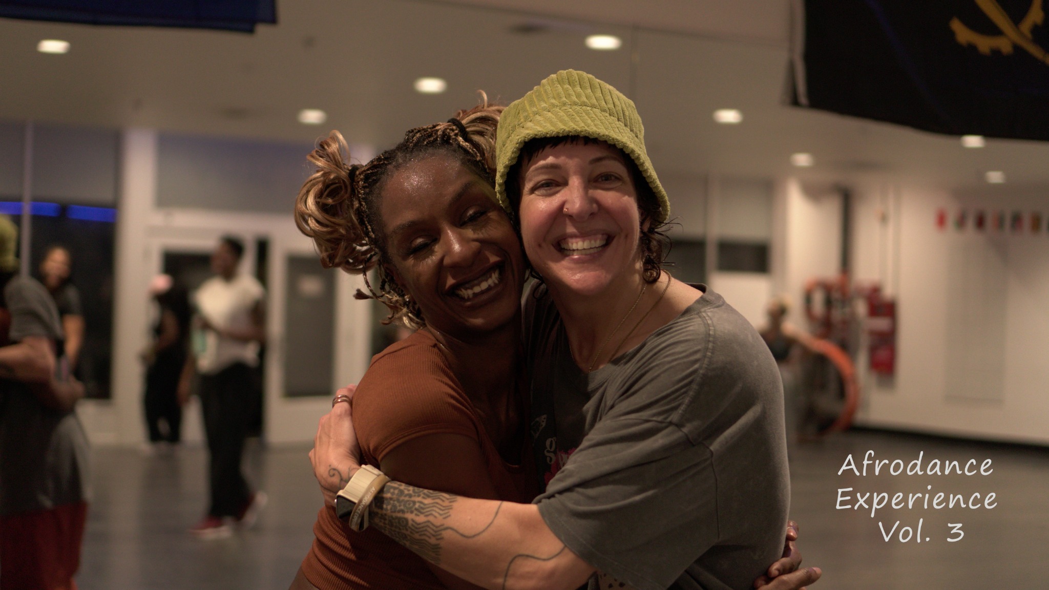 Two AfroDance Experience participants embracing
